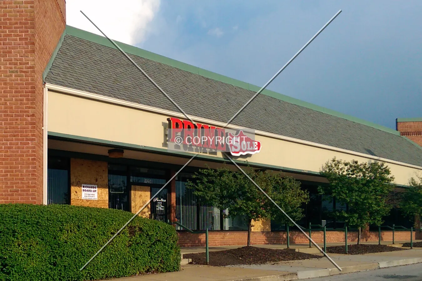 Prime Sole boarded up after looting and vandalism the evening before; August 11, 2014