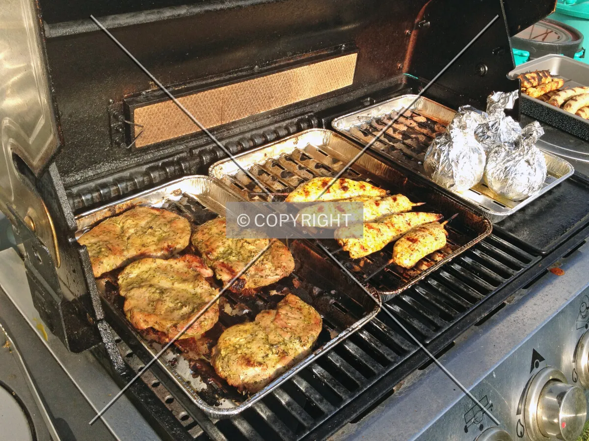 A barbecue grill and meat