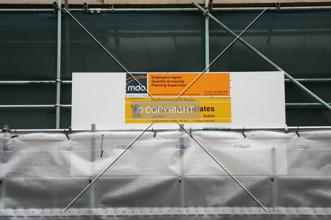 East side showing scaffold and contractors' signboards