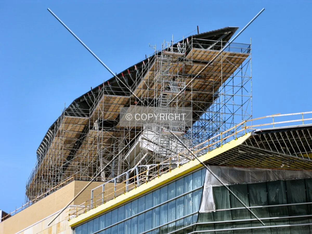 Scaffolding and the roof over the first base line bleachers