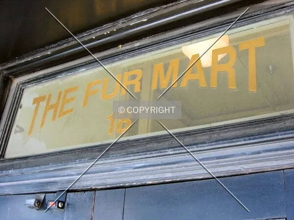 Fading sign above secondary entrance