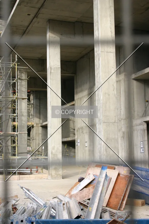 Concrete columns viewed through a hoarding