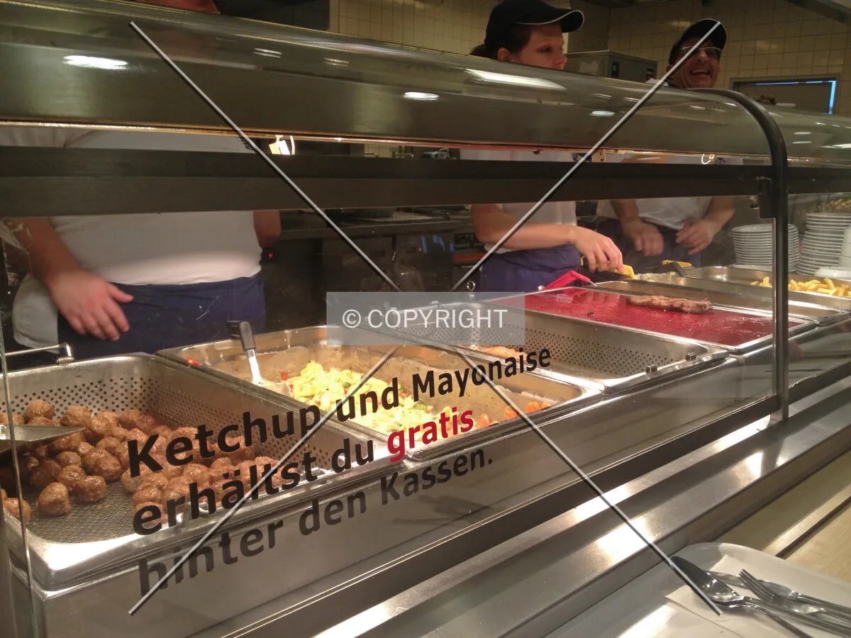 A self-service restaurant with employees serving the requested food
