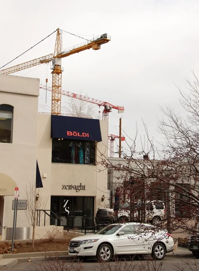 Tower cranes looming over the shops