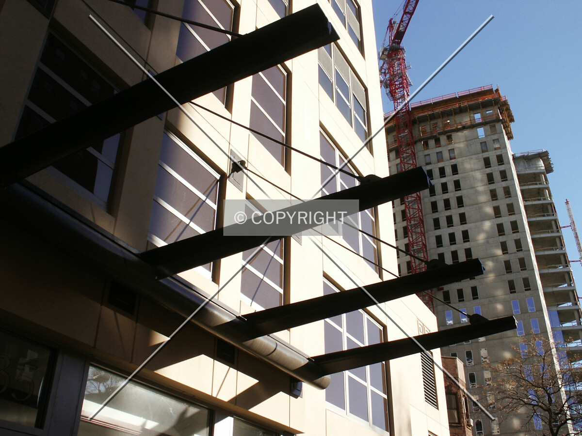 Entrance canopy framework with 30 West Oak in the background