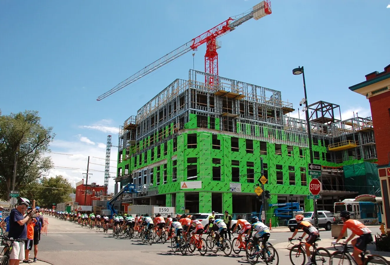 Cycle racers passing by the construction site
