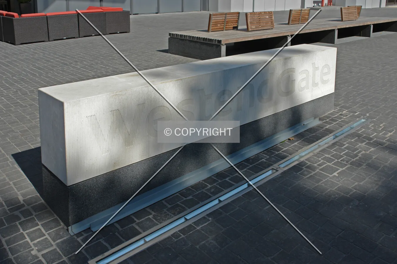 The logo of WestendGate on a seating bank in front of the building