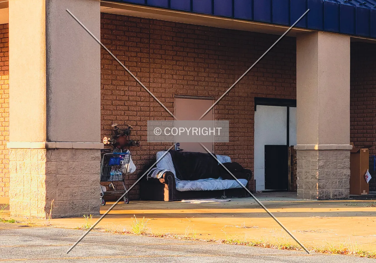 A couch and shopping cart near the front entrance; September 14, 2021