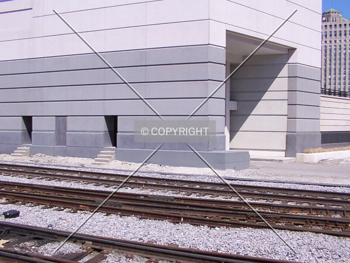 Southwest base of the building along the railroad tracks