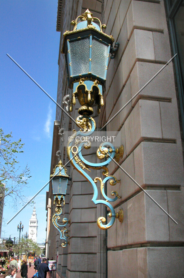 A pair of electric lamps guard the entrance