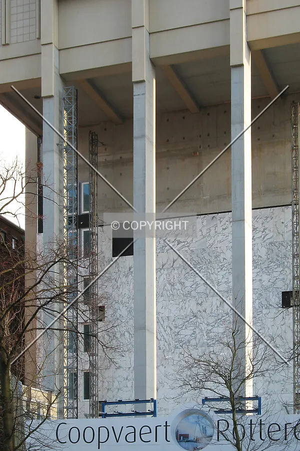 Marble cladding behind the three columns