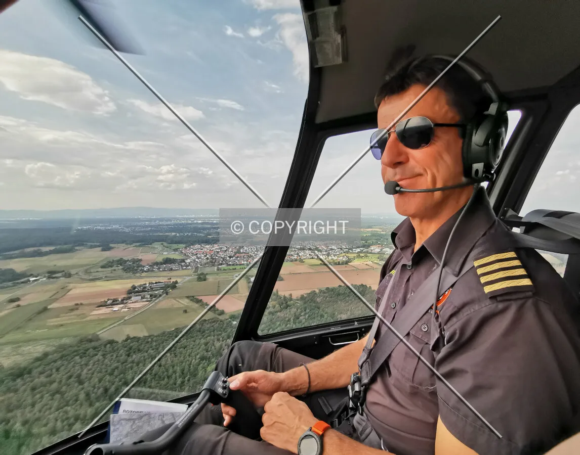 A pilot flying a helicopter