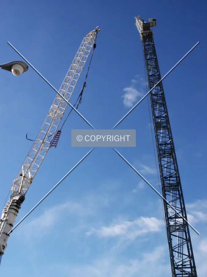 Looking up at the mobile crane and tower crane assembly from the east
