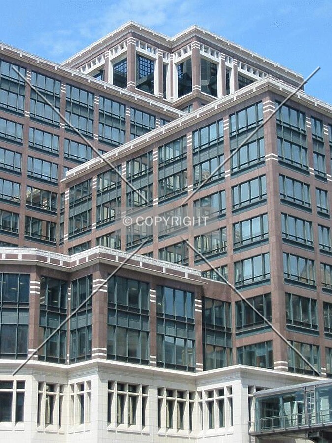 The complex setbacks and facade treatments seen from Heron Quay