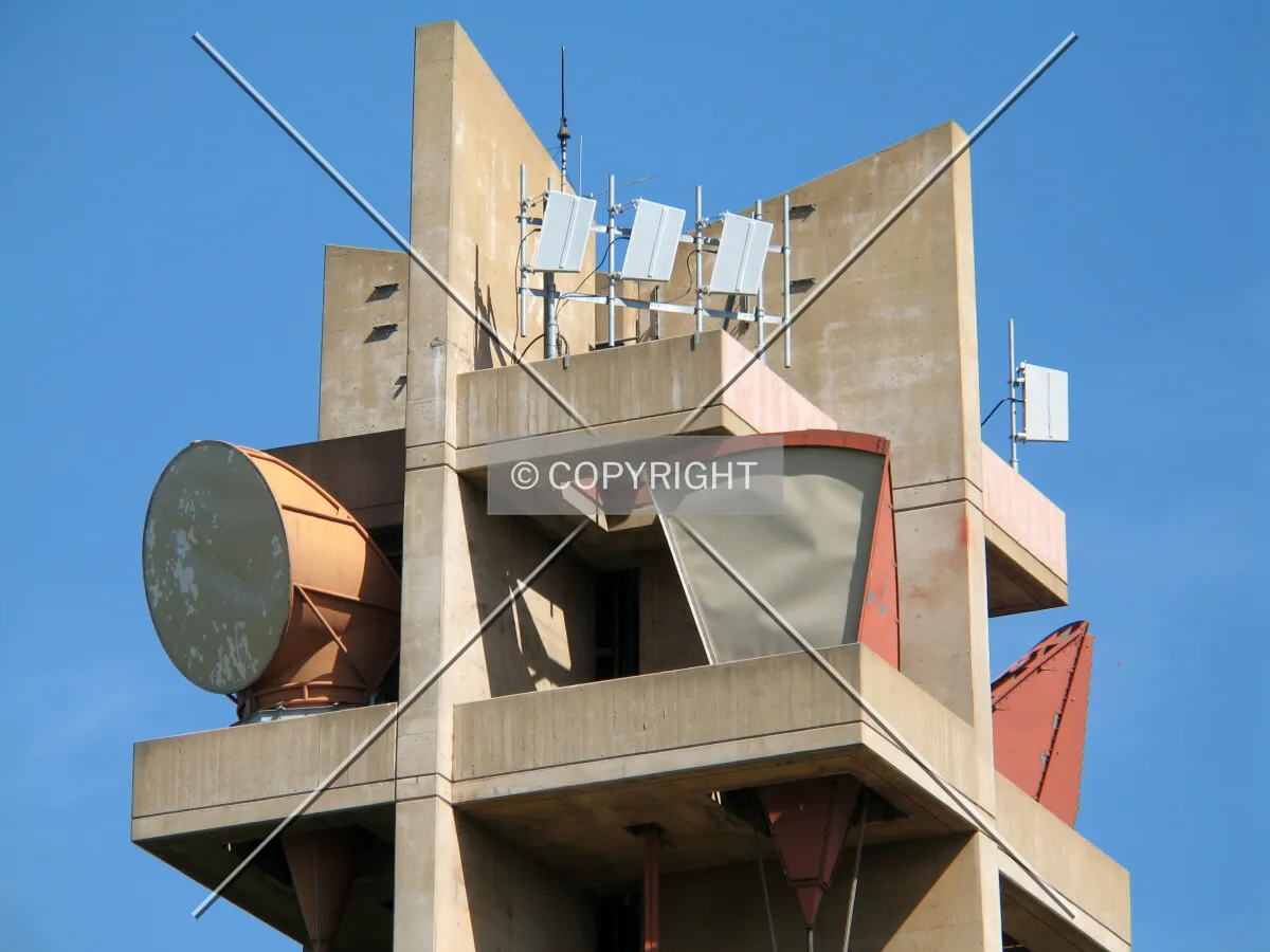 Several microwave, partial-section antennas occupy the top of the tower