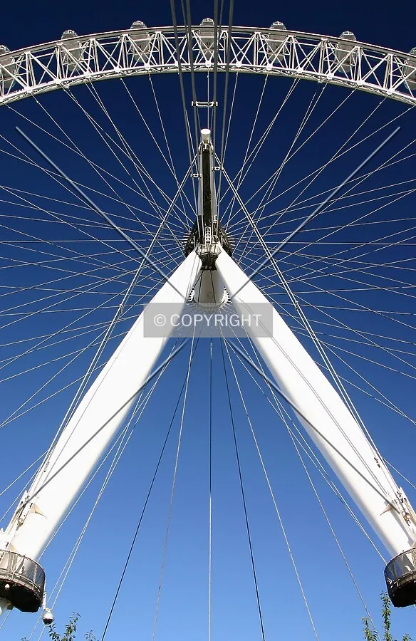 View west looking up at the A-frame, spindle, spokes and rim