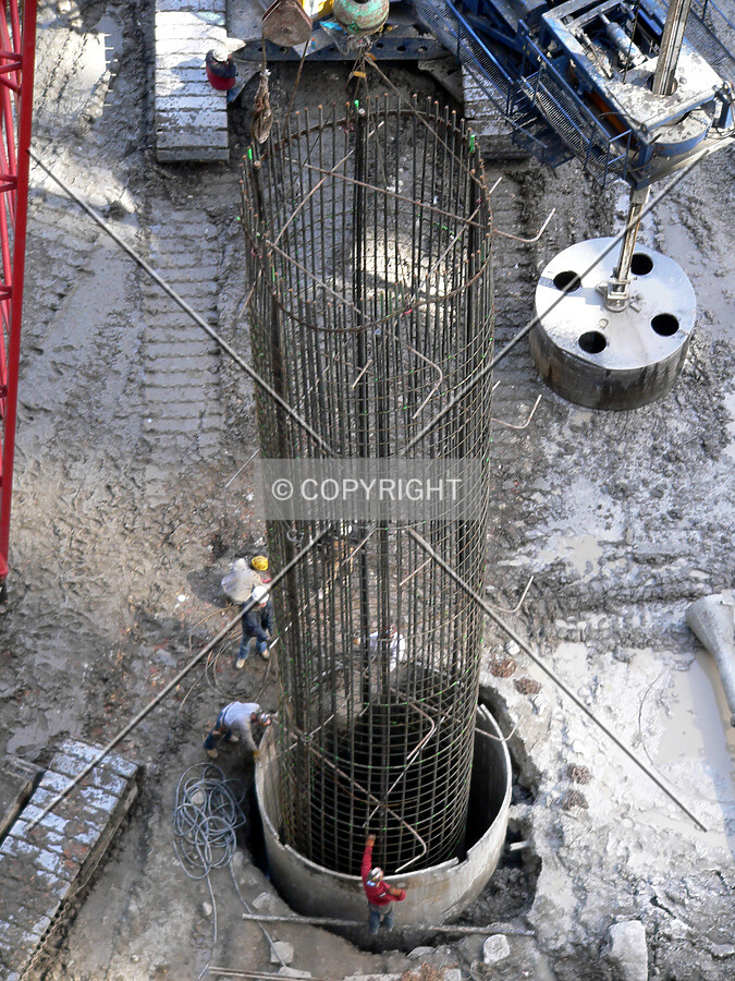 Lowering a rebar cage into a caisson hole