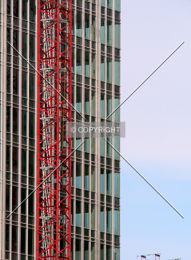 Floor plates showing through the facade with the tower crane visible