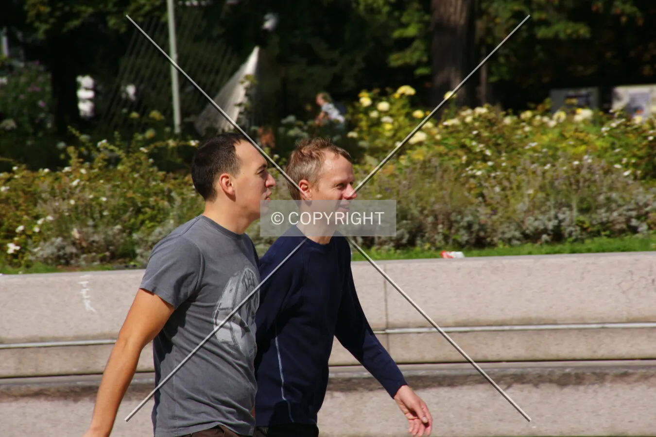 Two men are walking through the city center