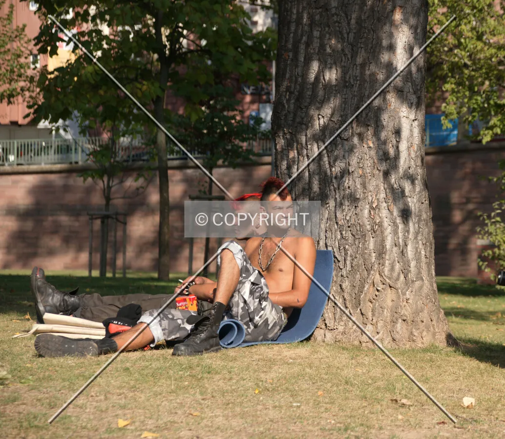 Two punks sitting in a park