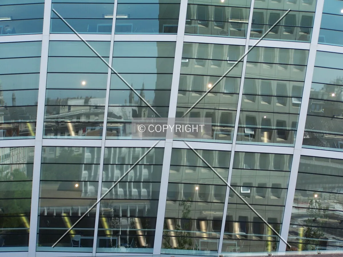 The town reflected in the glass of the municipal library's inverted pyramid