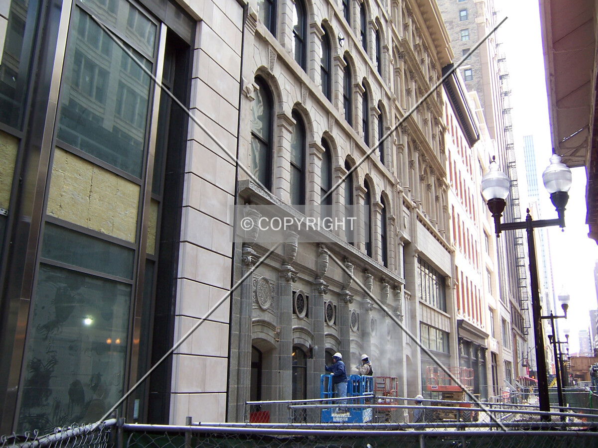Workers putting the finishing touches on the preserved Wabash Street facades
