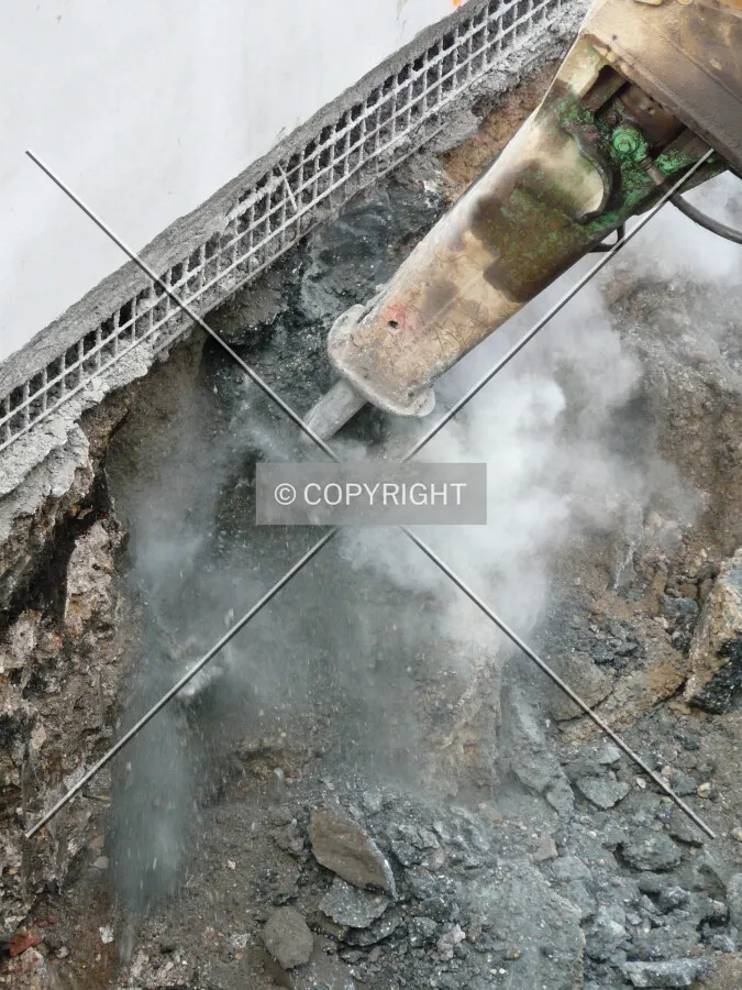 Breaking rocks under the north retaining wall
