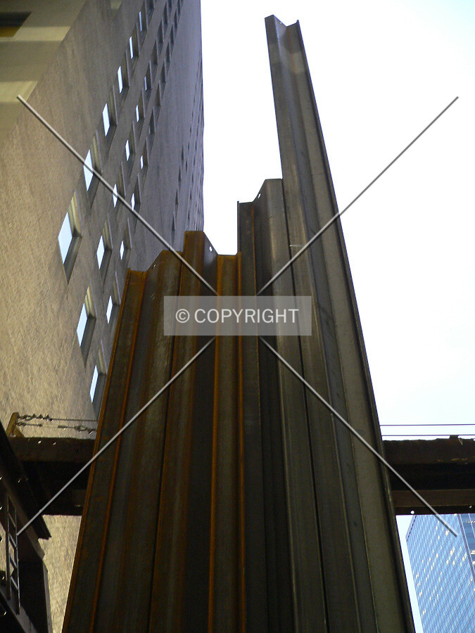 Steel sheeting rising above the alley on the southern perimeter of the site