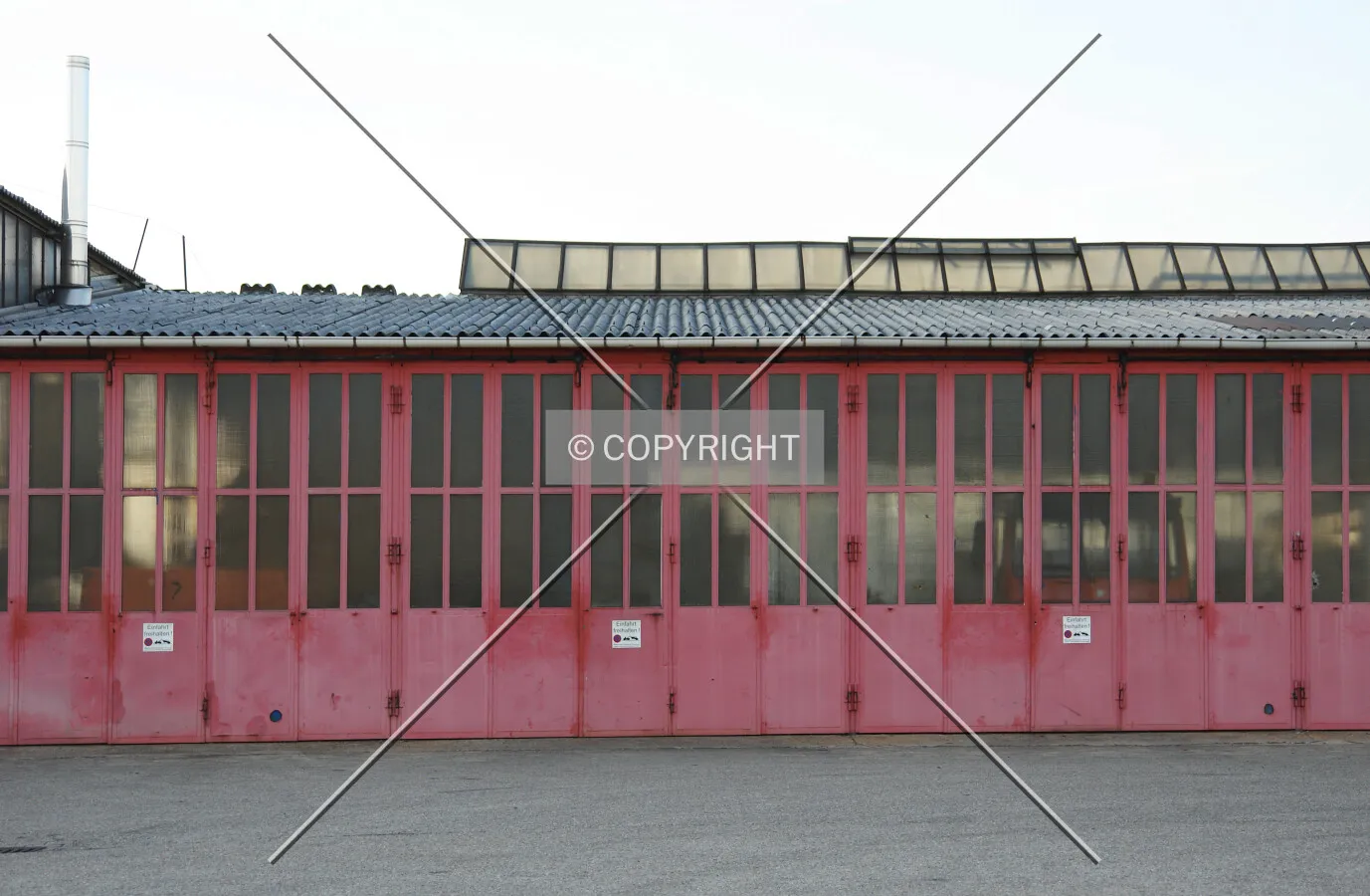 A industrial building with red gates