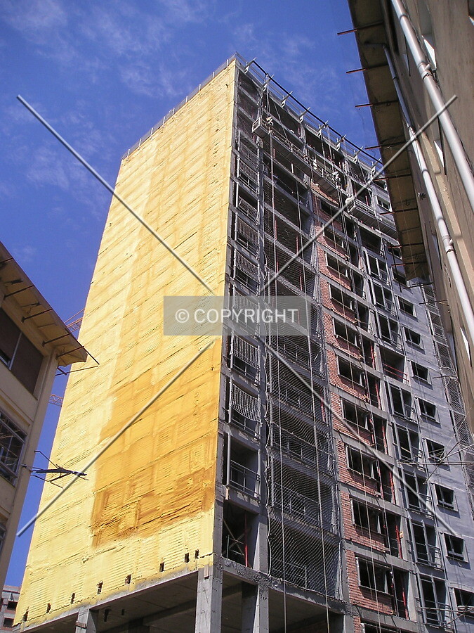 View of the yellow isolation material they have put on the north facade of the building