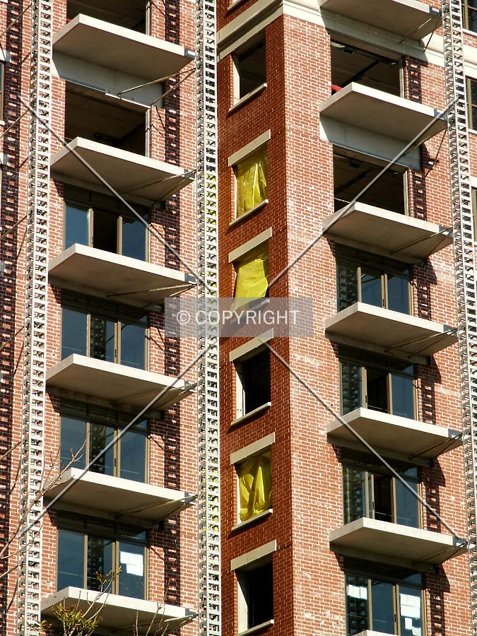 Notch in the east facade with yellow tarps in the windows