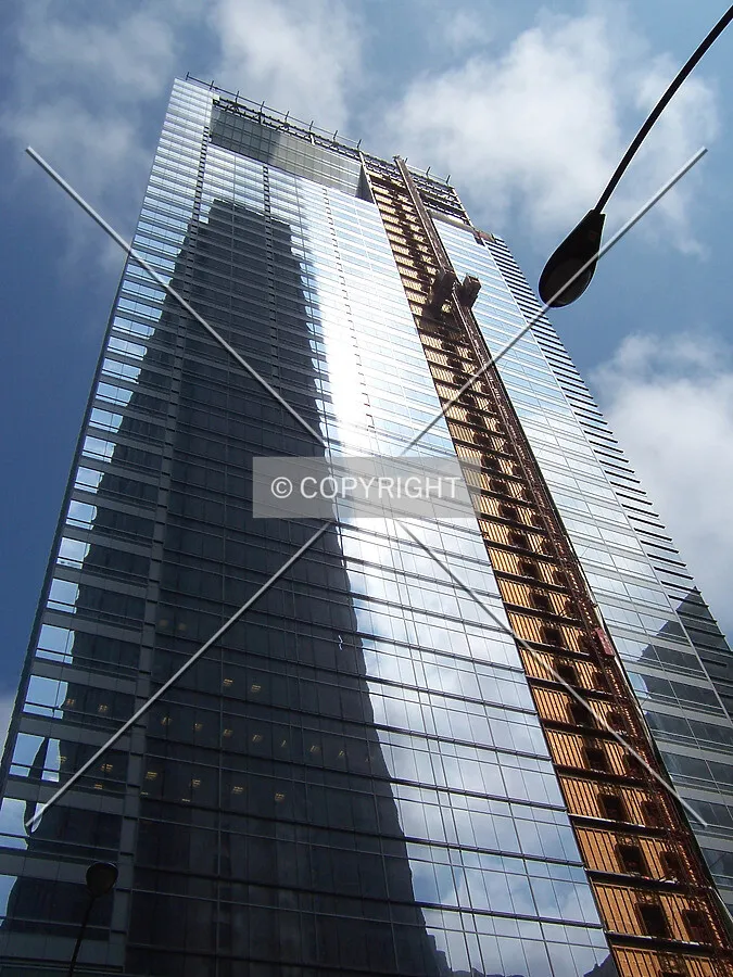 Looking up from the intersection of Madison and Dearborn Streets. A reflection of Bank One Plaza is cast onto the glass curtain wall