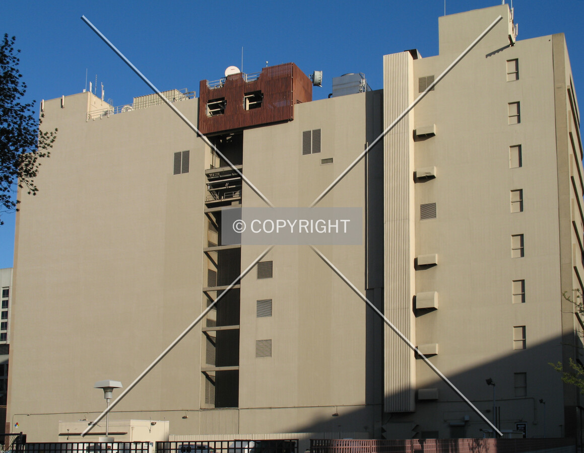 North side rises above a street-level parking lot