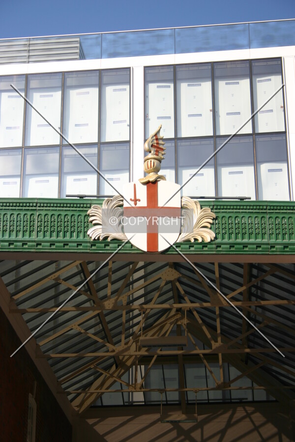 The top rising above the entrance to the ancient Spitalfields market which bears a crest of the City of London