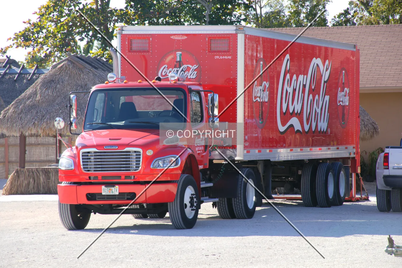 A Coke truck is unloading beverages