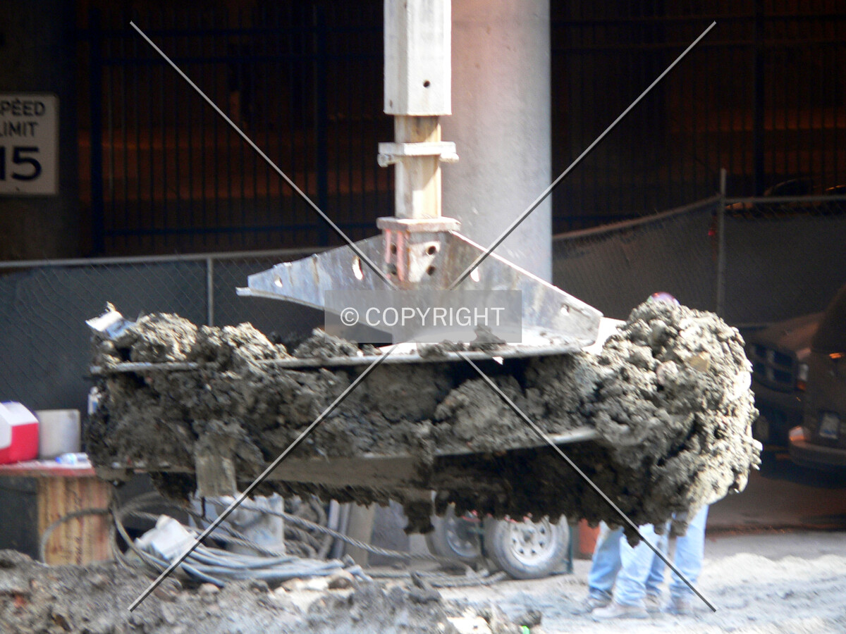 Removing clay from a caisson hole