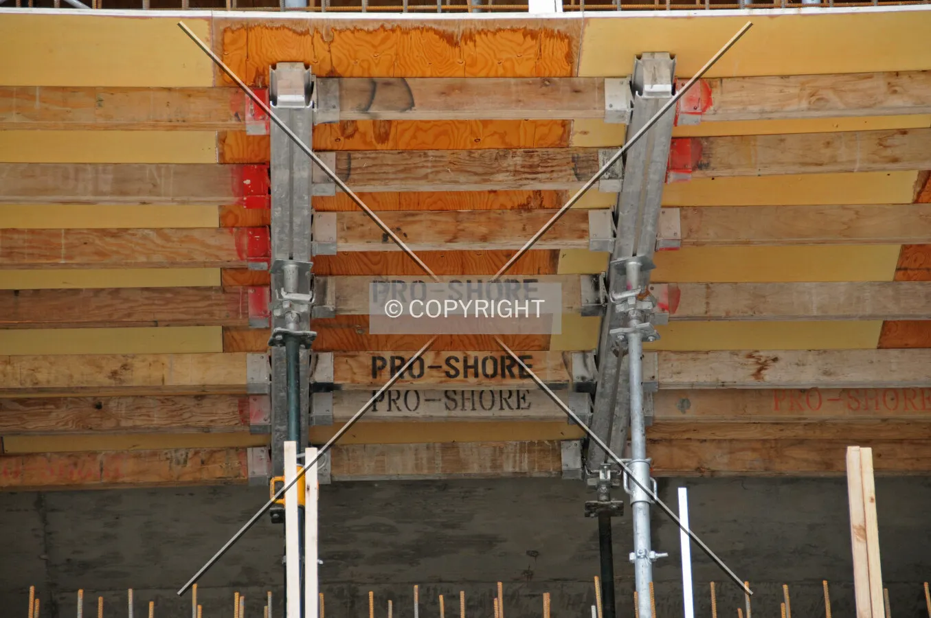 Pole shores and temporary decking holding a concrete slab in place while it cures
