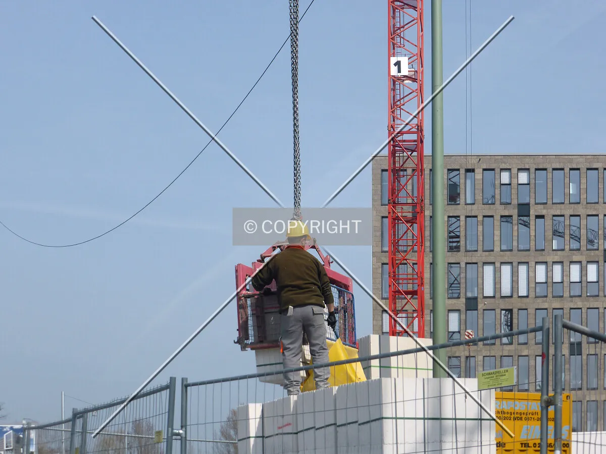 A construction worker and a crane