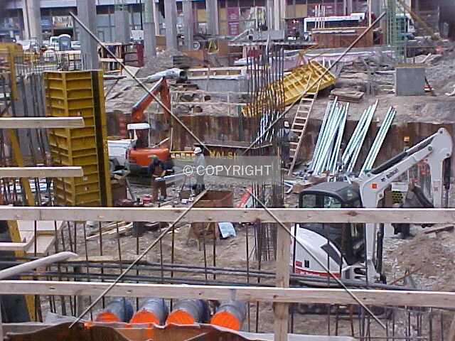 Construction workers down in the excavated lower level