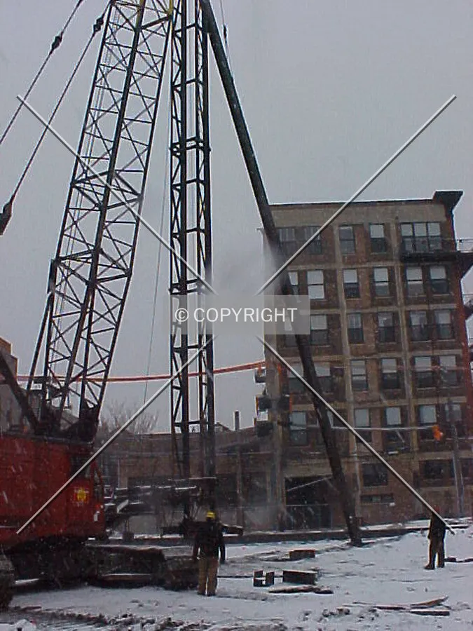 Lifting a steel pile into place so that it can be driven into the ground