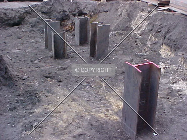 A cluster of steel piles emerging from the ground in the northwest corner of the project