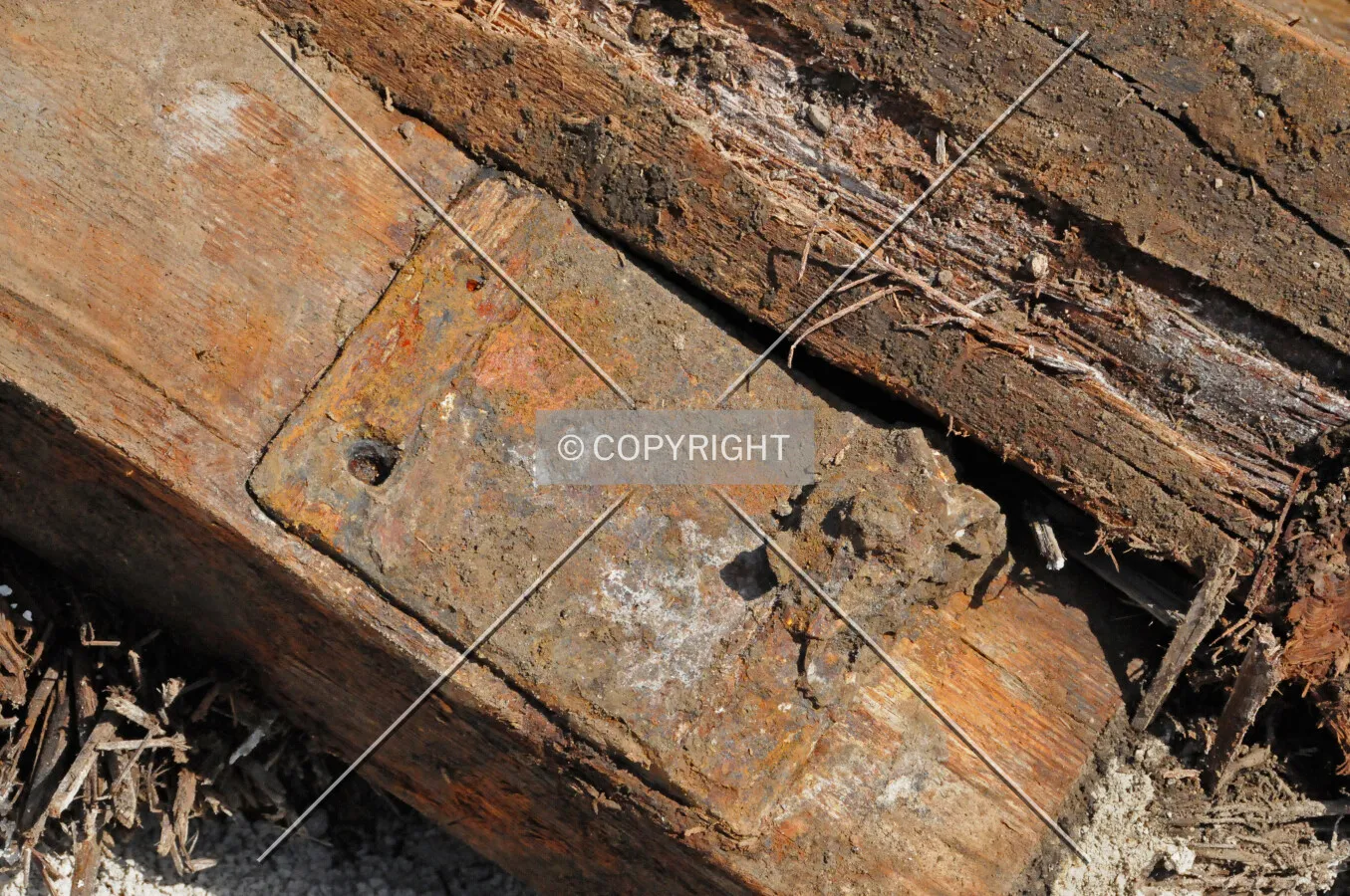 Old railroad ties and tie plates removed from Erie Street during the installation of new water pipes