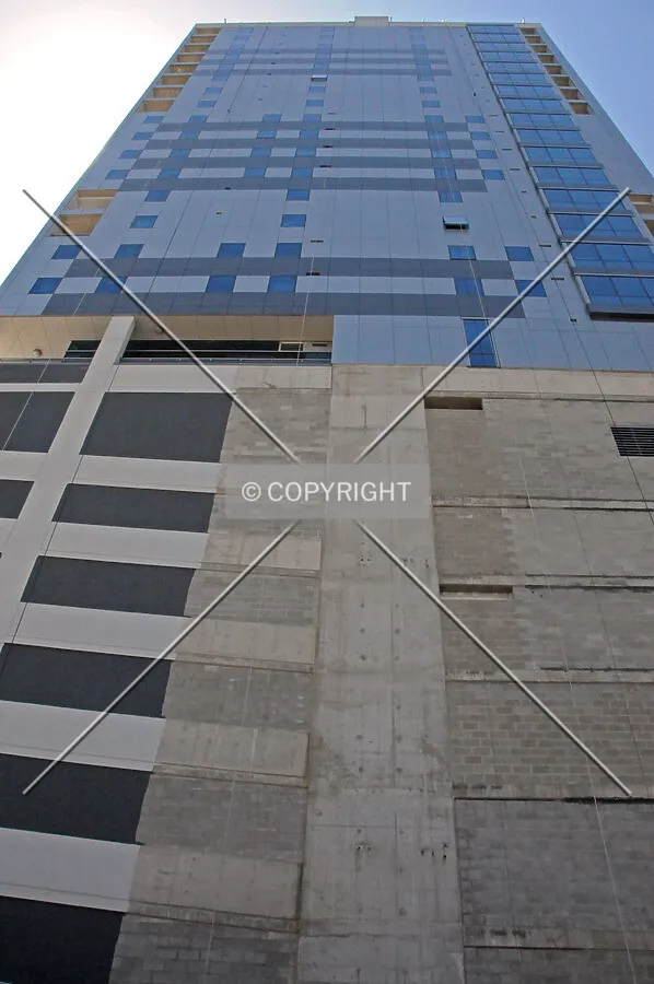 Looking up the east facade. The parking podium is in the process of being painted
