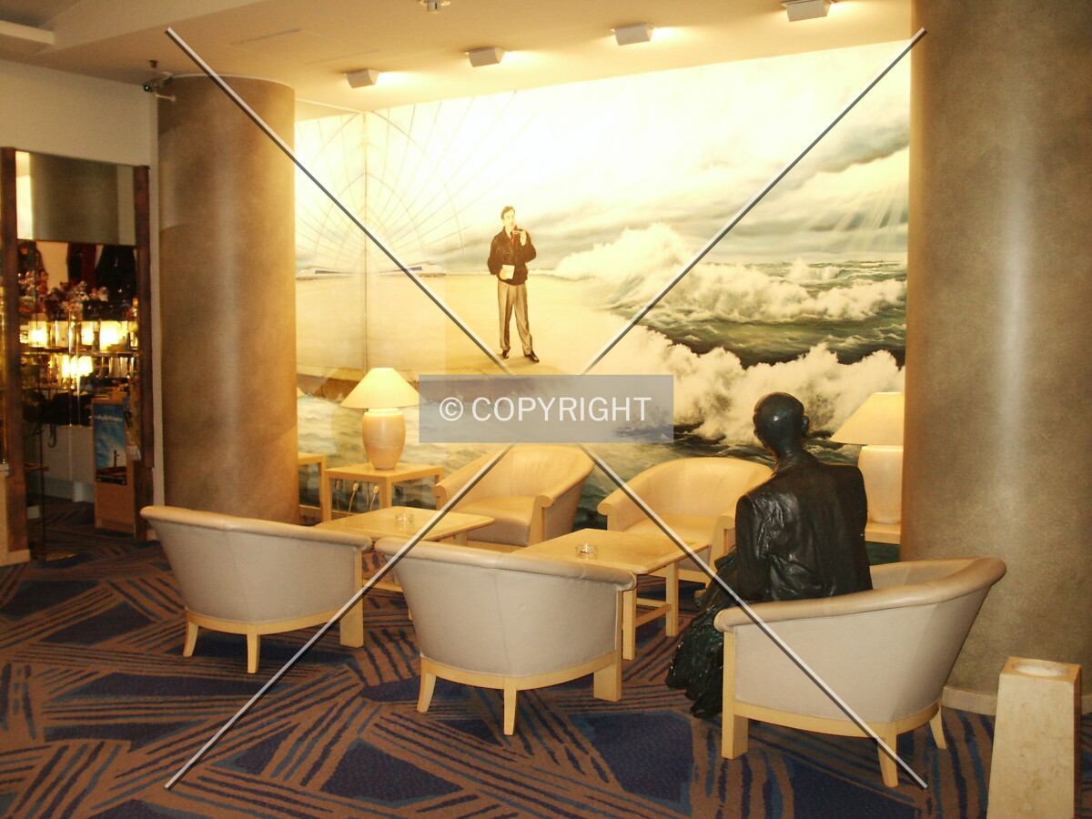 Statue looking at a mural in the lobby
