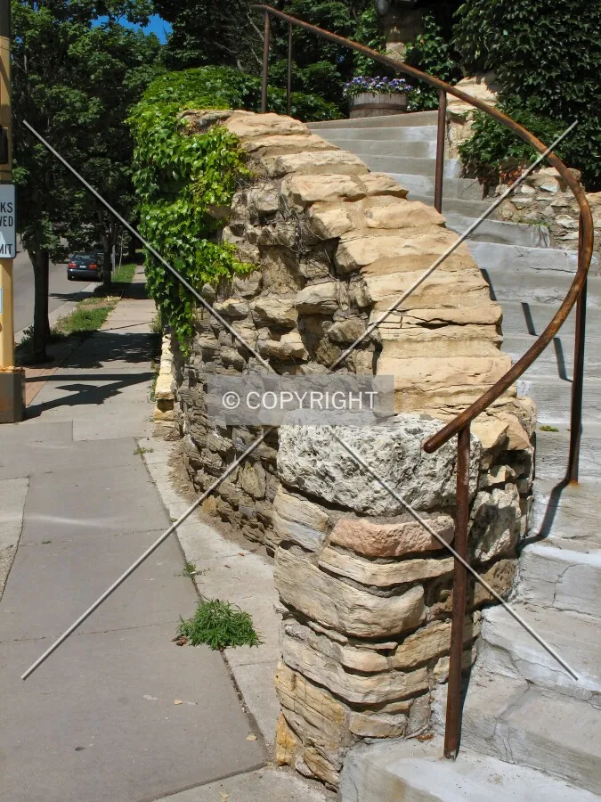Staircase retaining wall leaning over the Ramsey Street sidewalk