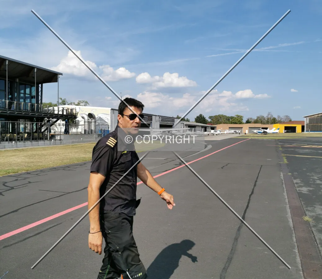 A helicopter pilot walking on an airfield