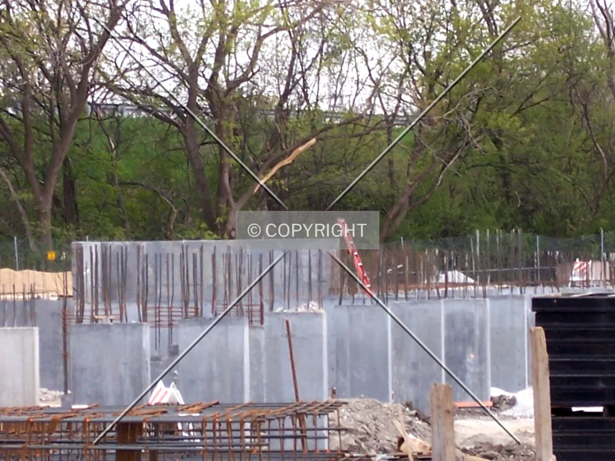 Looking south into the site, with a close-up view of the columns rising out of the lower level of the Elm Tower