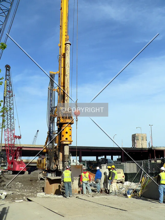 Finishing lowering a steel beam into the secant pile hole