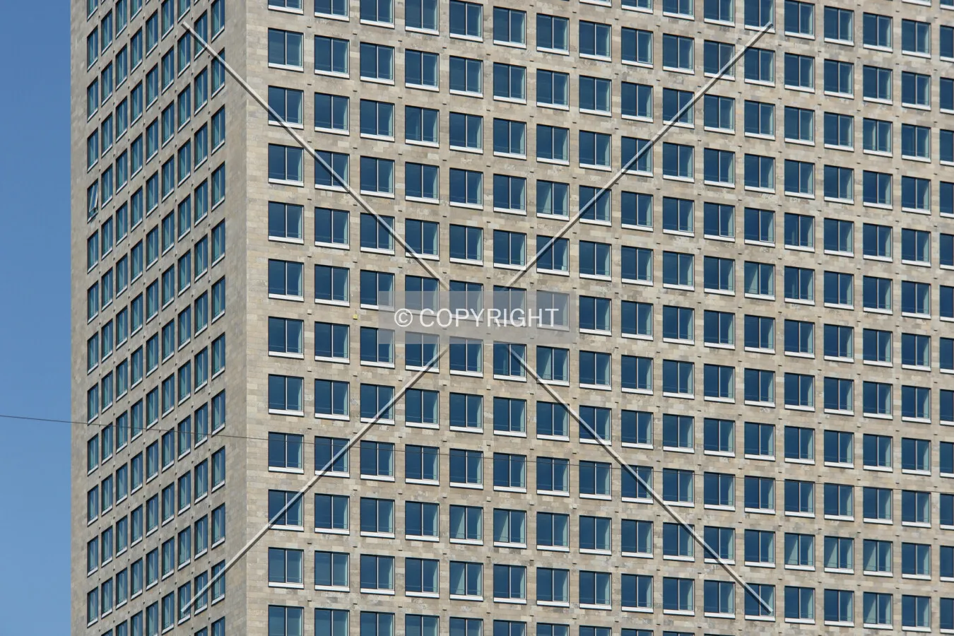 Gray facade of the office building and many windows