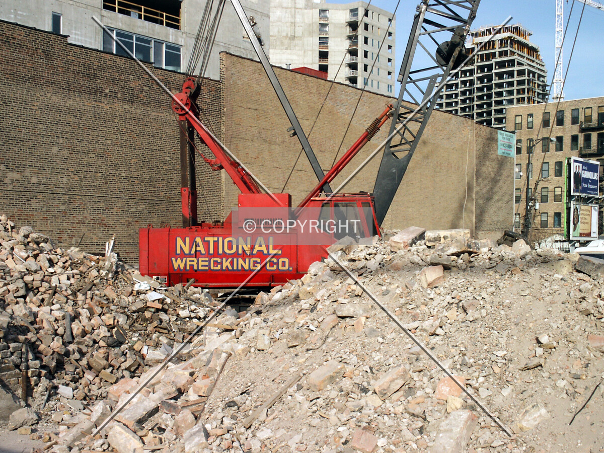 Demolition crane and rubble piles on the north side of the site